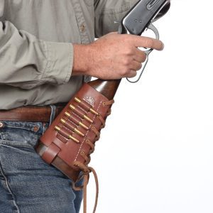 A person holding a lever-action rifle with a Western Cartridge Cuff on the stock, containing several bullets.